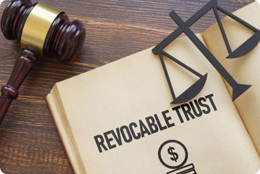 Image of a gavel on top of a revolvable trust, representing fairness and reliability. - The Law Office of Rebecca Sommer