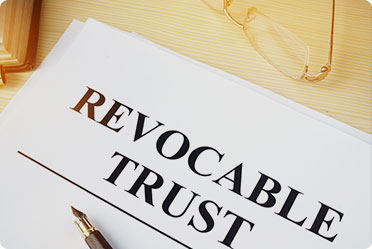 Revocable trust written in bold on the white paper. - The Law Office of Rebecca Sommer