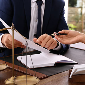 Attorney handing documents to client, symbolizing power of attorney authorization